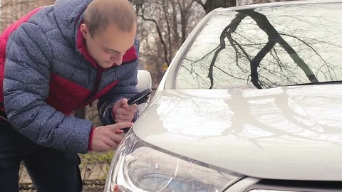 Owner of the car evaluating the condition of the body Stock Footage 83492646