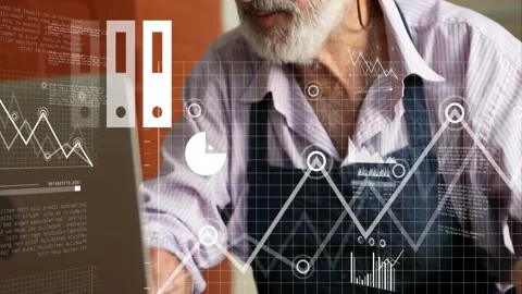 Owner glancing at laptop and typing while data charts, cloud overlaying ledger Stock Footage 331832620