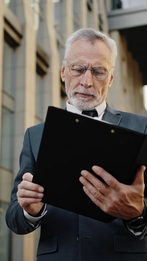 Owner of restaurant chain checks project plan on clipboard Stock Footage 329785308