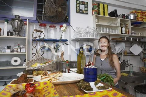 Owner Sitting At Counter In Restaurant Stock Photos