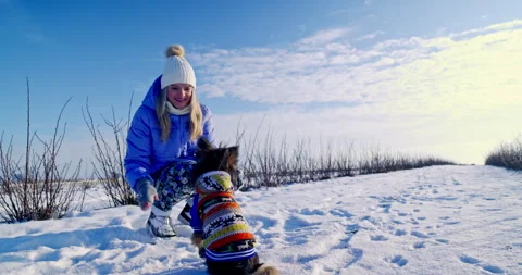 The owner spends time with her small dog outside. Stock Footage 253226827