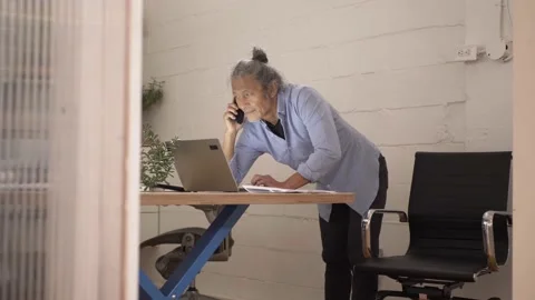 Owner of startup business working with digital devices in workspace Stock Footage 221038097