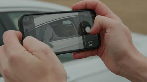 The owner, upon discovering the shattered window, captures photographic evidence Stock Footage 267073702