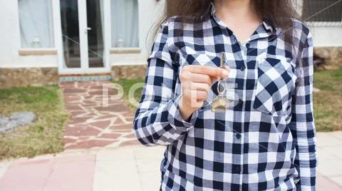 Ownership, property and tenant concept - key in female hand for new home and Stock Photos