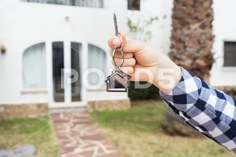 Ownership, property and tenant concept - key in female hand for new home and Stock Photos