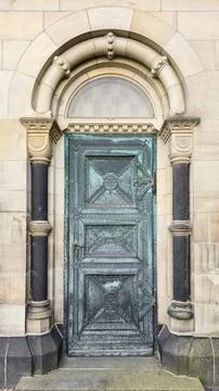  Oxidized copper door in arched stone entrance, vintage metal portal, mas.. Stock Photos