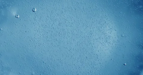 Oxygen bubbles in water on a blue abstract background Stock Footage 329846173