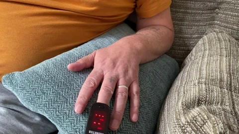 Oxygen levels test indicator device on finger of adult checking oxygen levels Video stock 135682696