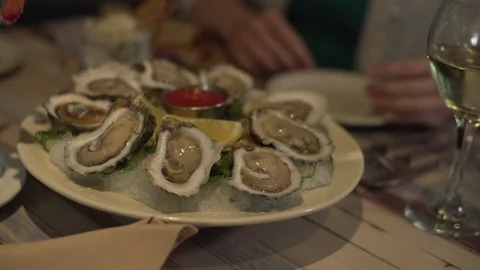 Oysters on half shell in a plate in slow motion Stock Footage 112031678
