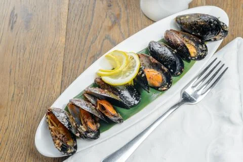 Oysters with lemon Stock Photos