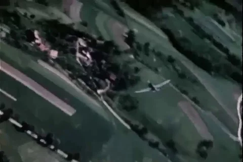 P-47 buzzing town, circling low over countryside - 1945 Stock Footage 104634390