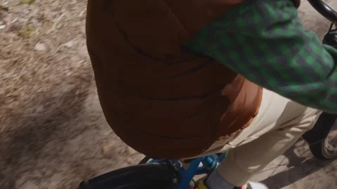 P view of boy right leg on pedal during cycling Stock Footage 316581285