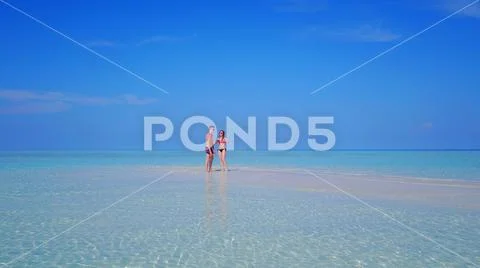 P00086 Aerial flying drone view of Maldives white sandy beach 2 people young Stock Photos