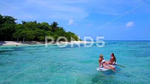 P02079 Aerial flying drone view of Maldives white sandy beach 2 people young Stock Photos