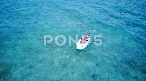 P02088 Aerial flying drone view of Maldives white sandy beach 2 people young Stock Photos