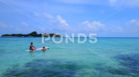 P02112 Aerial flying drone view of Maldives white sandy beach 2 people young Stock Photos