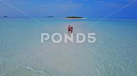 P02217 Aerial flying drone view of Maldives white sandy beach 2 people young Stock Photos