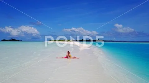 P02540 Aerial flying drone view of Maldives white sandy beach 2 people a young Stock Photos