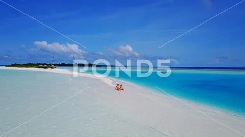 P02544 Aerial flying drone view of Maldives white sandy beach 2 people a young Stock Photos