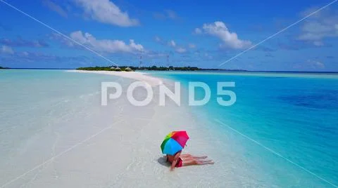 P02552 Aerial flying drone view of Maldives white sandy beach 2 people a young Stock Photos