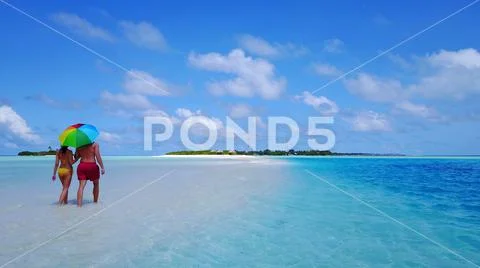 P02583 Aerial flying drone view of Maldives white sandy beach 2 people a young Stock Photos