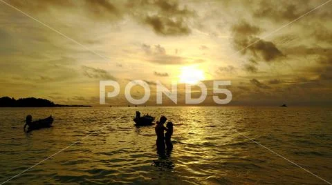 P02970 Aerial flying drone view of Maldives white sandy beach 2 people young Stock Photos
