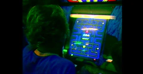 Pac-Man arcade gamers playing classic coin-op machine 1982 Stock Footage 318348814