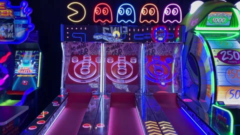 Pac-Man themed skee-ball bowling arcade machine with glowing neon lights Dave-17 Stock Footage 339490750
