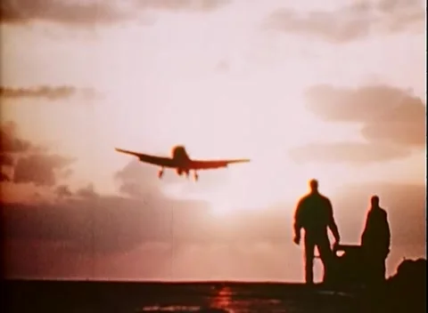 PACIFIC - 1943: Dusk operations - A figure sprints into the setting light Stock Footage 343931742