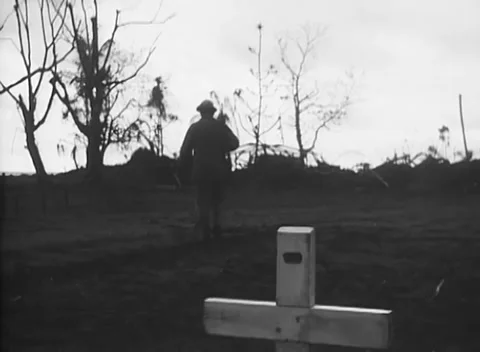 PACIFIC - 1944: Backlit clearing - Man stands behind white cross Vidéo 344487937