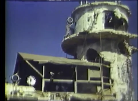 PACIFIC - 1945: Airfield control - A battered tower rises over a ruin Stock Footage 343931979