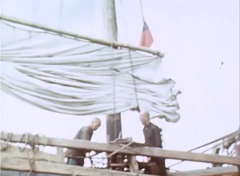 PACIFIC - 1945: Boarded vessel - Men work a junk deck among barrels Stock Footage 343931567