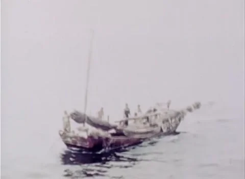 PACIFIC - 1945: Intercepted craft - A junk lies close with her sails slack Stock Footage 343931509