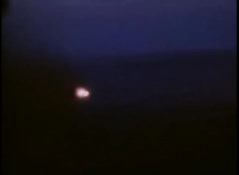 PACIFIC - 1945: Night strike - A single orange point burns in the dark Stock Footage 343931182