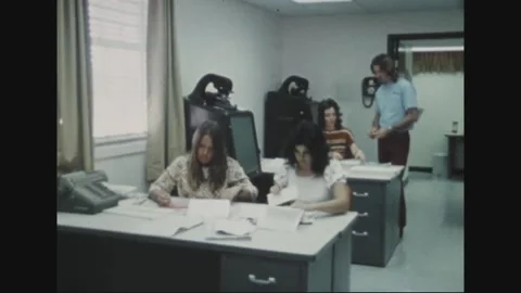 PACIFIC - 1973: Office paperwork - Staff handle records across two desks Stock Footage 344497323