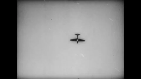PACIFIC - CIRCA 1945: Naval guns fire as an aircraft passes overhead Stock Footage 339065363