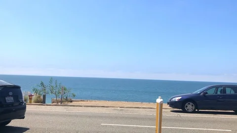 Pacific Coast Highway ocean view with cars passing by Stock Footage 96088397