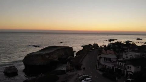 Pacific Coast Ocean Sunset with Rock Formations and Traffic, California, Aerial Stock Footage 145458014