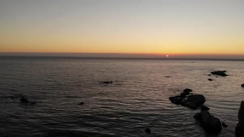 Pacific Coast Ocean Sunset with Rock Formations and Traffic, Aerial View Stock Footage 145468524
