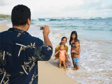 Pacific Islander father taking photograph of family Stock Photos