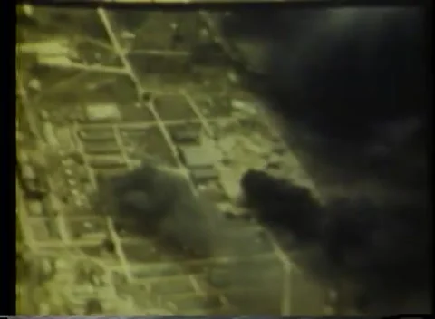 PACIFIC OCEAN - 1943: Air attack - A Town Or Airfield With Dark Smoke Stock Footage 343786414