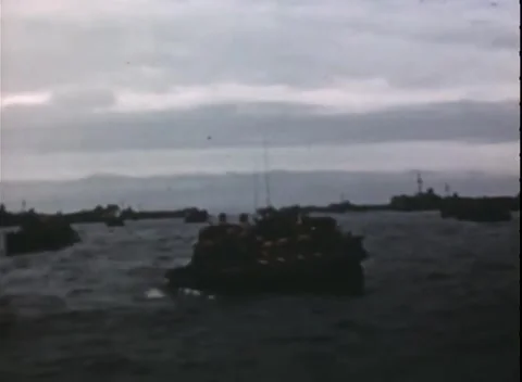 PACIFIC OCEAN - 1944: Amphibious force — amphibious craft with ships beyond Stock-Footage 343119980