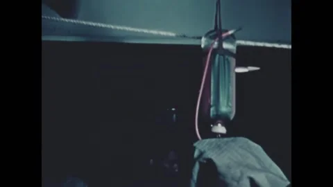 PACIFIC OCEAN - 1944 - A wounded serviceman smokes while he is operated on. 스톡 동영상 331213656