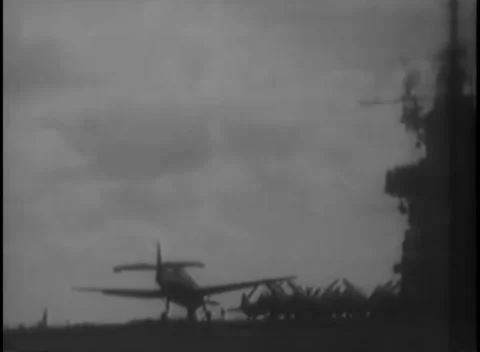 PACIFIC OCEAN - 1945: Carrier deck — an aircraft on deck below the island Stock Footage 343119688