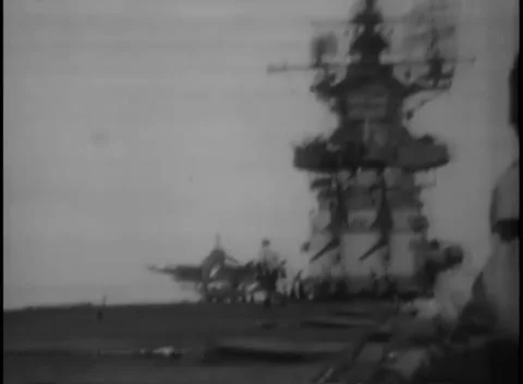 PACIFIC OCEAN - 1945: Carrier deck — deck crew stand by the island structure Stockbeeldmateriaal 343119721