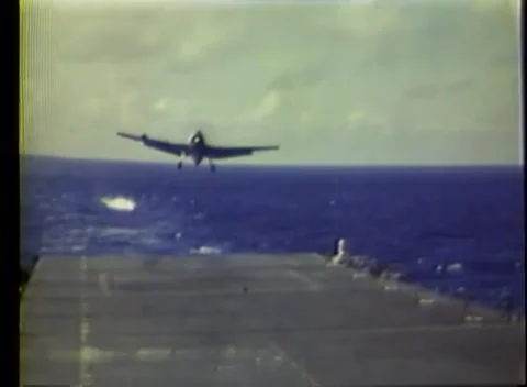 PACIFIC OCEAN - 1945: Carrier flight — single-engine plane banks over the sea Stock Footage 343120219