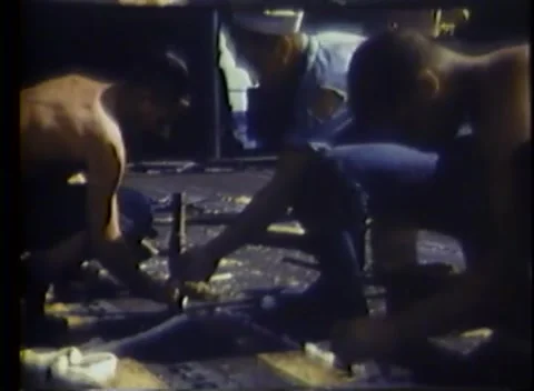 PACIFIC OCEAN - 1945: Deck carpentry — kneeling work with hand tools Vidéo 343119782