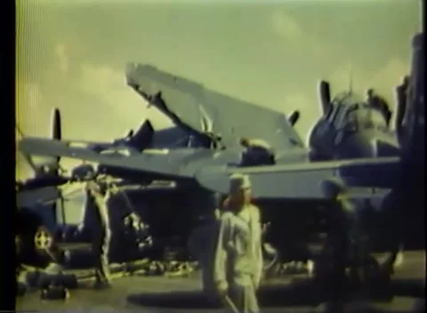 PACIFIC OCEAN - 1945: Deck crew detail — crew gather at a folded-wing plane Видео 343120237