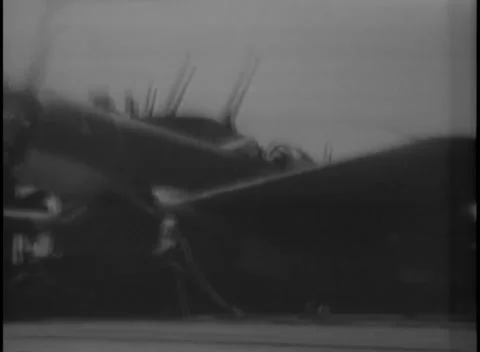 PACIFIC OCEAN - 1945: Deck handling — a folding-wing plane taxis with wings up Video stock 343119704