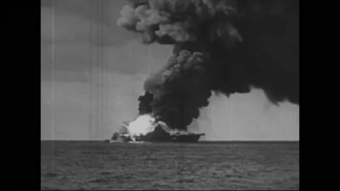 PACIFIC OCEAN - 1945 - Distant views of the USS Franklin going up in flames Stock Footage 304157197